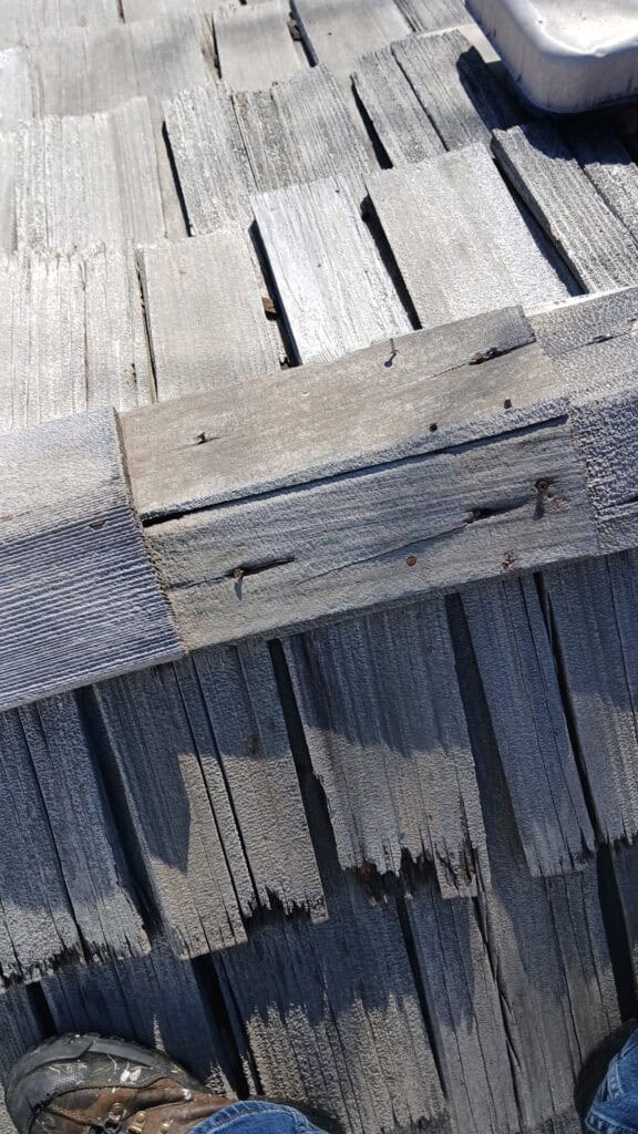 Aging cedar shake roof showing signs of wear on a Hinsdale home